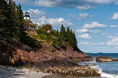 Owls Head Lighthouse Over Rocky Cliffs at Low Tide